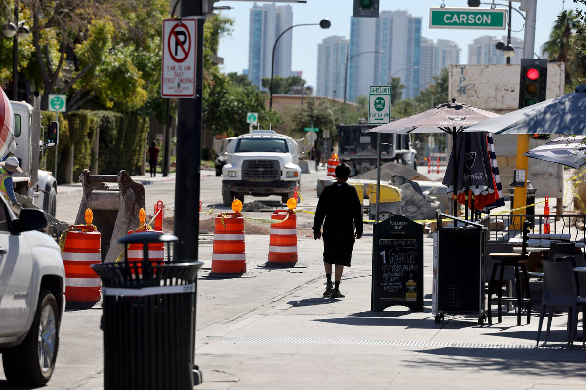 A pedestrian walks on Seventh Street at Carson Avenue in downtown Las Vegas as construction con ...
