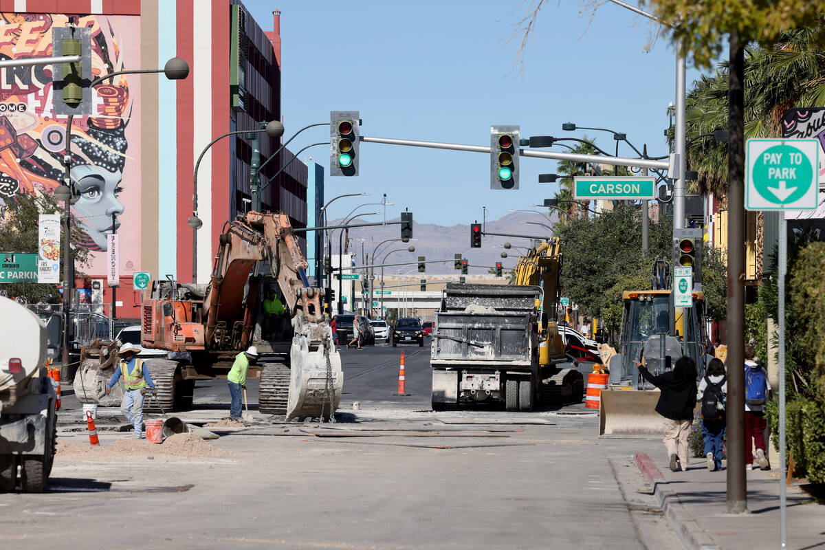 Pedestrians walk on Seventh Street between Bridger and Carson avenues in downtown Las Vegas as ...