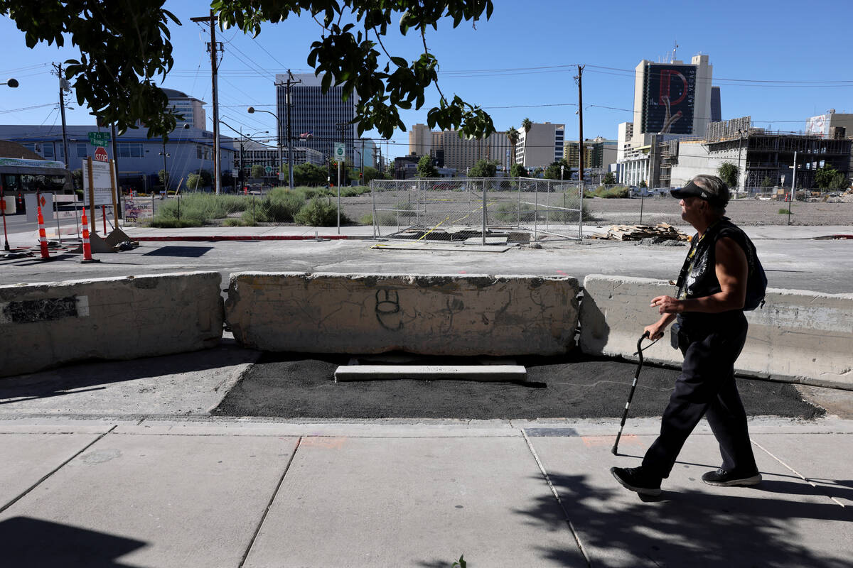 A pedestrian walks on Seventh Street between Bridger and Carson avenues in downtown Las Vegas a ...