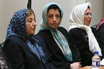 FILE - Prominent Iranian human rights activist Narges Mohammadi, center, sits next to Iranian N ...