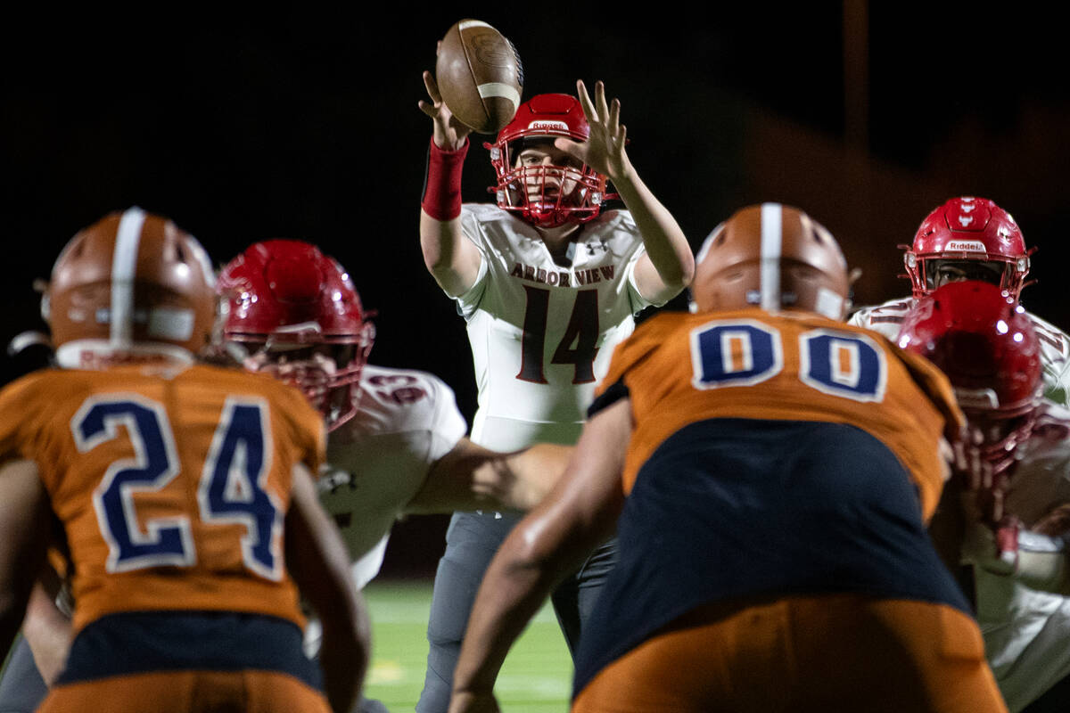 Arbor View quarterback Alonzo Balderrama (14) catches the snap during a high school football ga ...