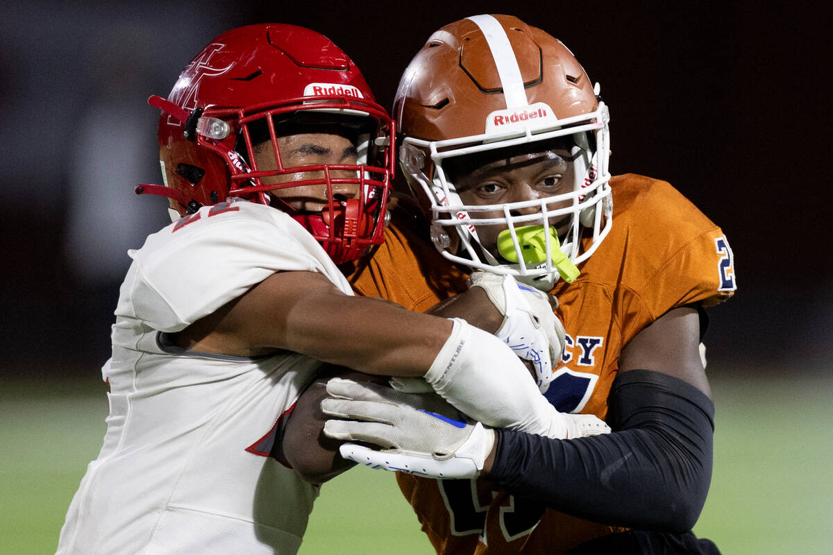 Arbor View cornerback Adrian Peterson (22) pushes Legacy running back Airamis Craven (21) out o ...