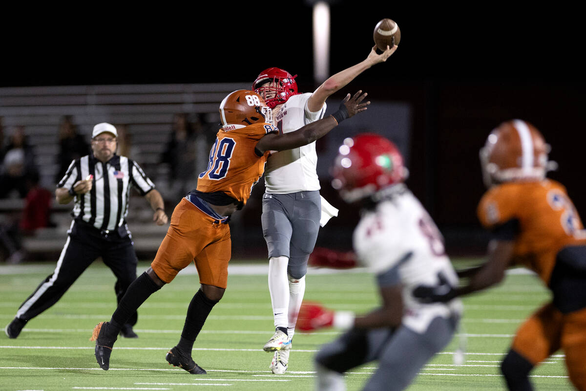 Arbor View quarterback Alonzo Balderrama (14) passes while Legacy’s Semaj Williams (88) ...