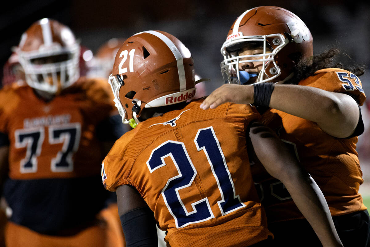 Legacy guard Jonathon Gomez (53) congratulates Legacy running back Airamis Craven (21) on his t ...