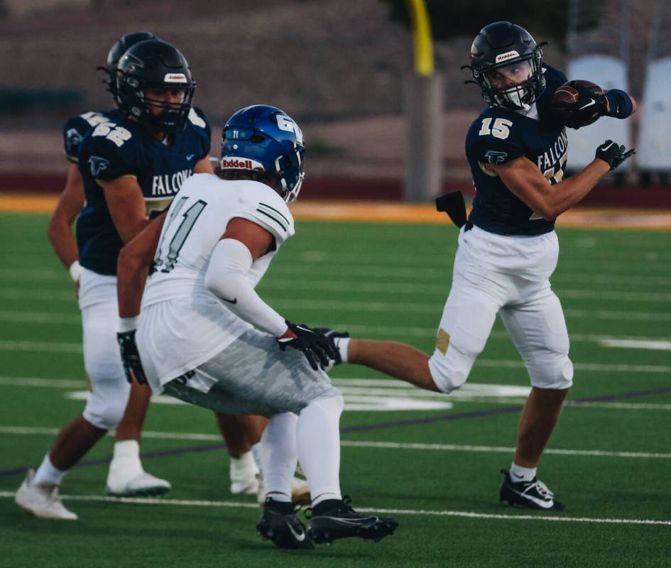 Foothill wide receiver Braxton Bonnett (15) keeps the ball away from Green Valley linebacker Ga ...