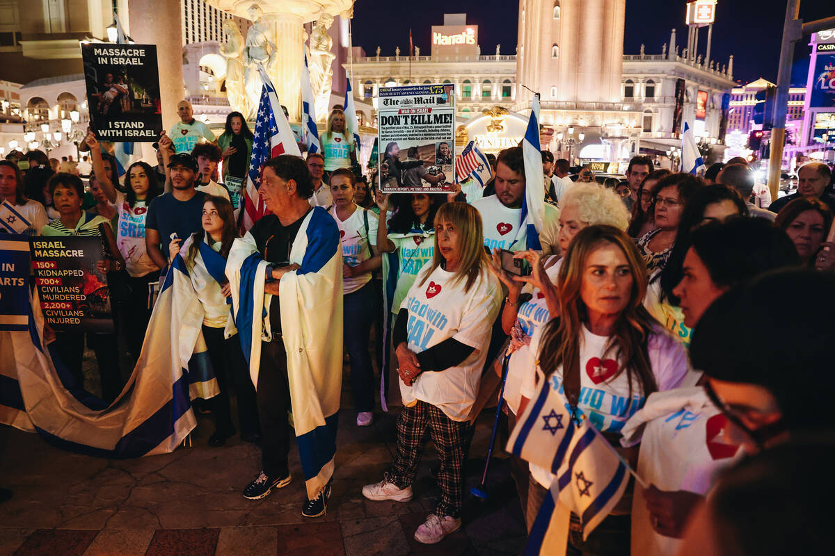 A vigil takes place during a pro-Israel rally outside the Venetian on Sunday, Oct. 8, 2023, in ...