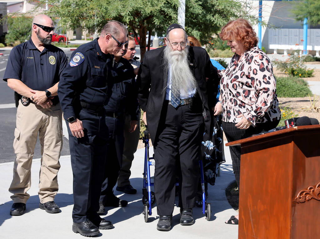 Hal Goldblatt, center, who is still recovering after being hit by a car a year ago, gets up to ...