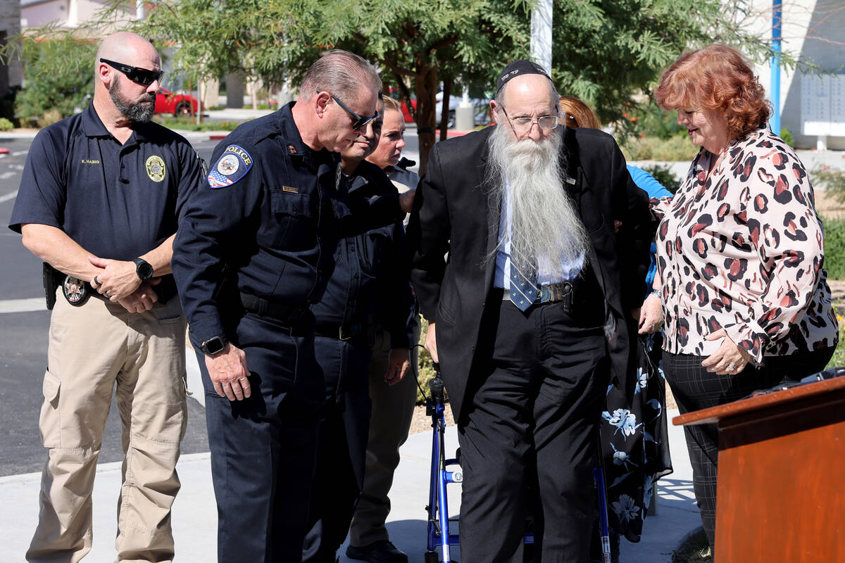 Hal Goldblatt, center, who is still recovering after being hit by a car a year ago, gets up to ...