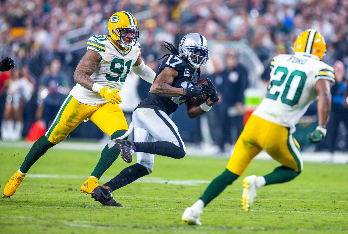 Raiders wide receiver Davante Adams (17) splits the defense after a catch between Green Bay Pac ...