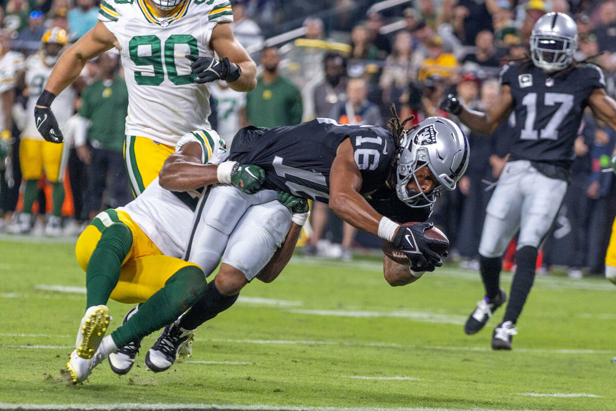 Raiders wide receiver Jakobi Meyers (16) extends over the goal line with Green Bay Packers safe ...