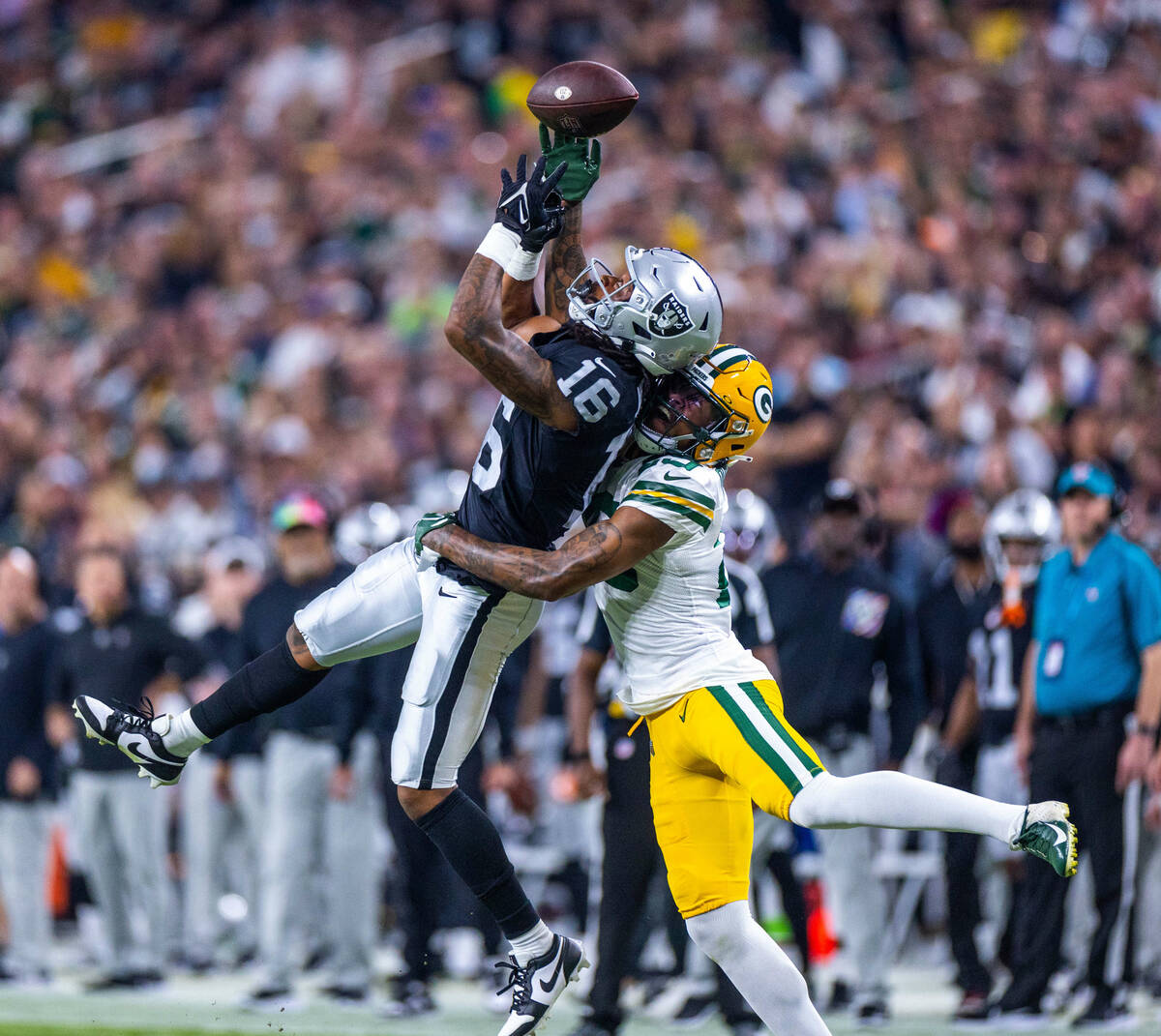 Raiders wide receiver Jakobi Meyers (16) battles for a reception with Green Bay Packers cornerb ...