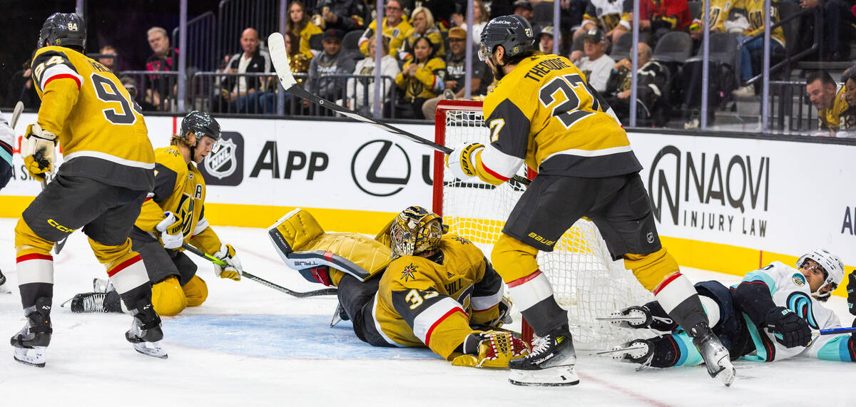 Golden Knights center William Karlsson (71) and goaltender Adin Hill (33) defend the net as Se ...