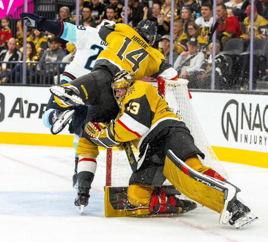 Golden Knights goaltender Adin Hill (33) defends the net as Seattle Kraken defenseman Vince Dun ...