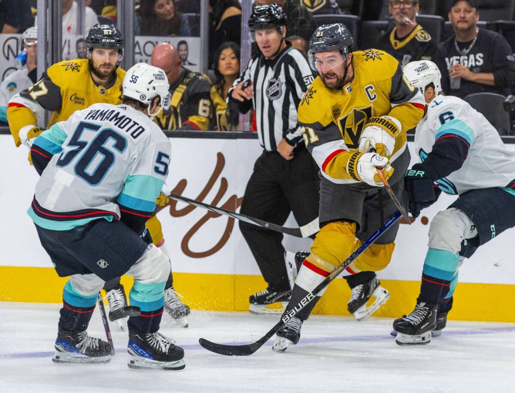 Golden Knights right wing Mark Stone (61) passes past Seattle Kraken right wing Kailer Yamamoto ...