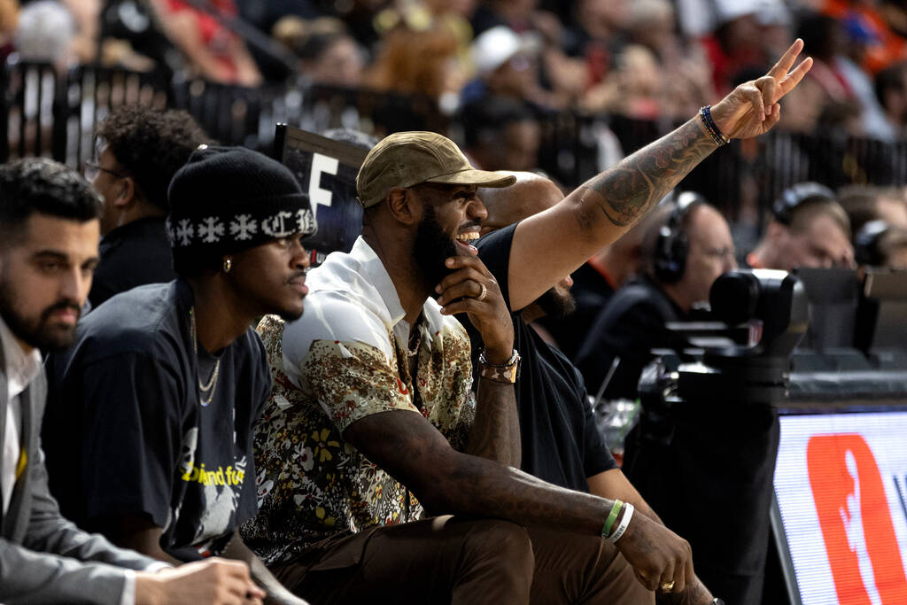 NBA superstar LeBron James laughs on the sidelines during the second half in Game 1 of the WNBA ...