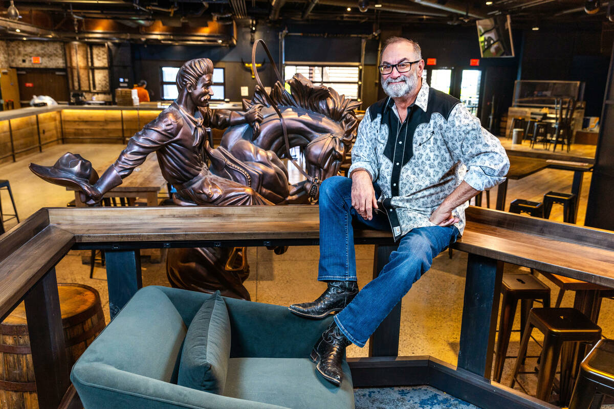 Stoney's North Forty owner Chris Lowden with a cowboy riding a bucking horse art piece as part ...