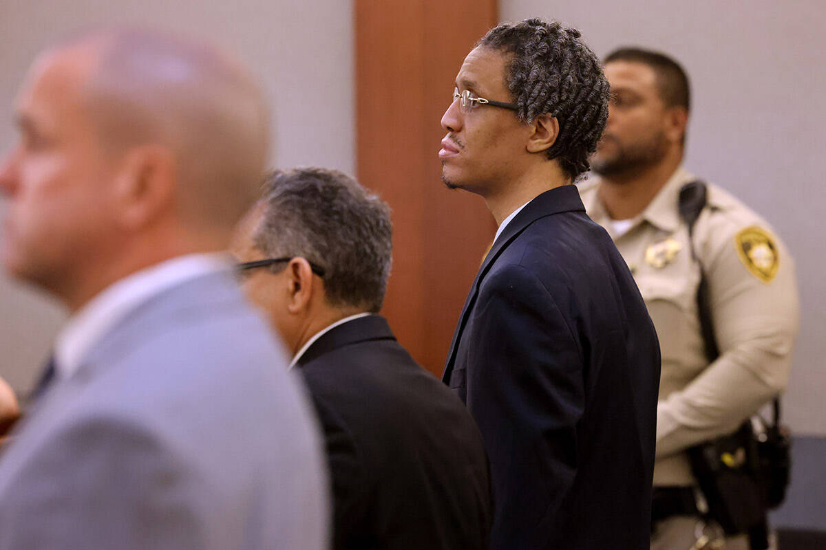 Omar Talley, accused of killing two women near the Strip stands as the jury enters the courtroo ...