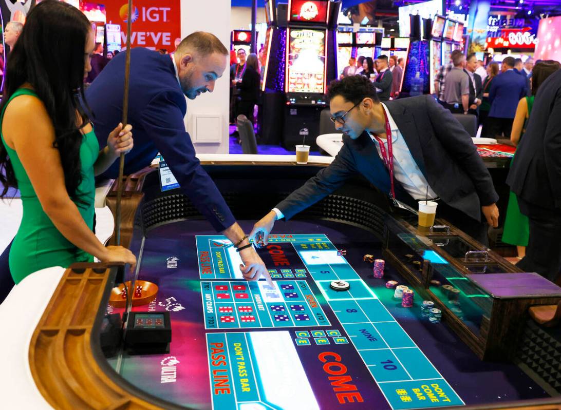 Conventioneers play on TCSJohnHuxley's Craps table at G2E Las Vegas, on Tuesday, Oct. 10, 2023, ...
