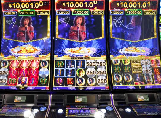 IGT's Skyrise cabinets with Whitney Houston video slots are displayed at IGT booth at G2E Las ...