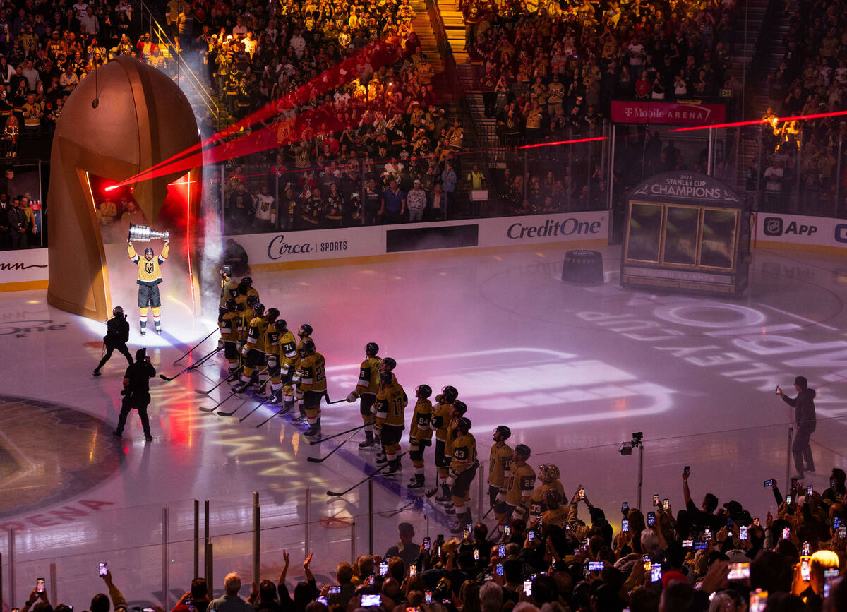 Golden Knights right wing Mark Stone (61) carries out the Stanley Cup during the raising of the ...