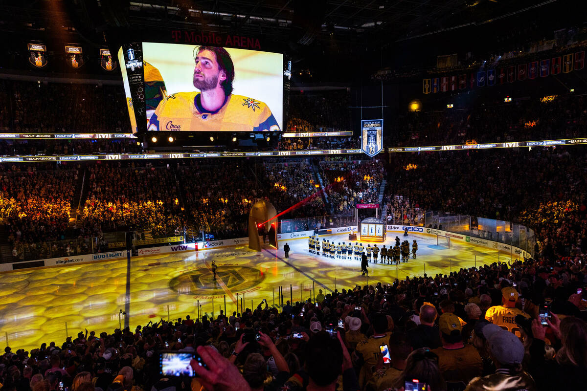 Golden Knights players gather during the raising of the 2023 Stanley Cup Championship banner be ...