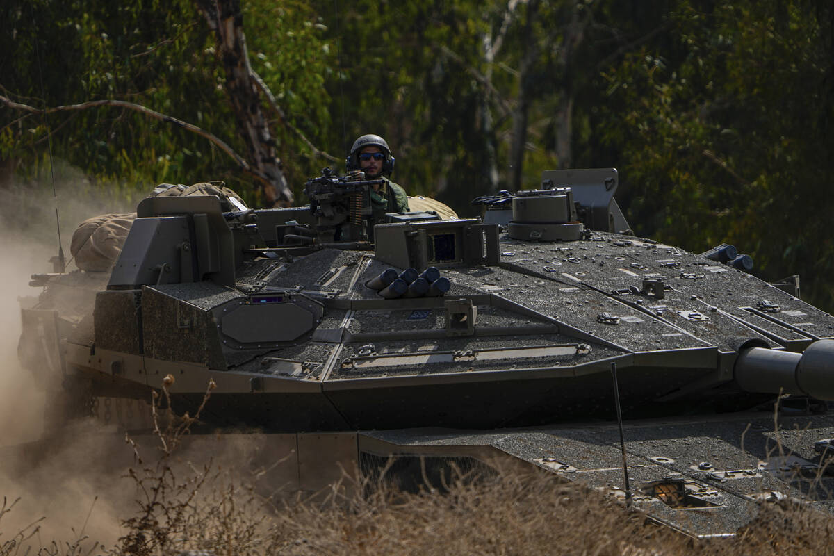 Israeli tanks are stationed near the border with Lebanon Wednesday, Oct. 11, 2023. (AP Photo/Ar ...