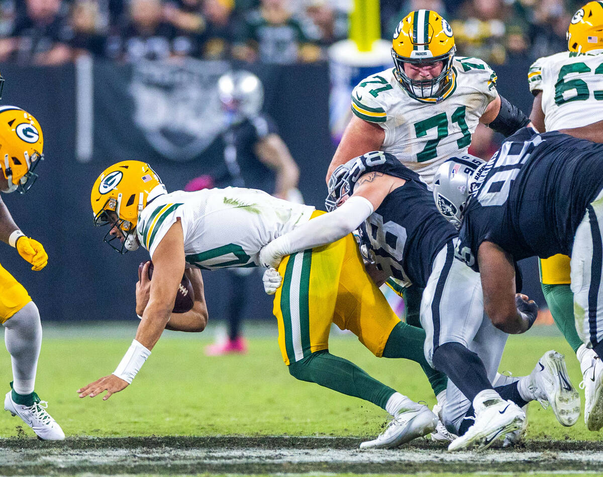 Green Bay Packers quarterback Jordan Love (10) is sacked by Raiders defensive end Maxx Crosby ( ...