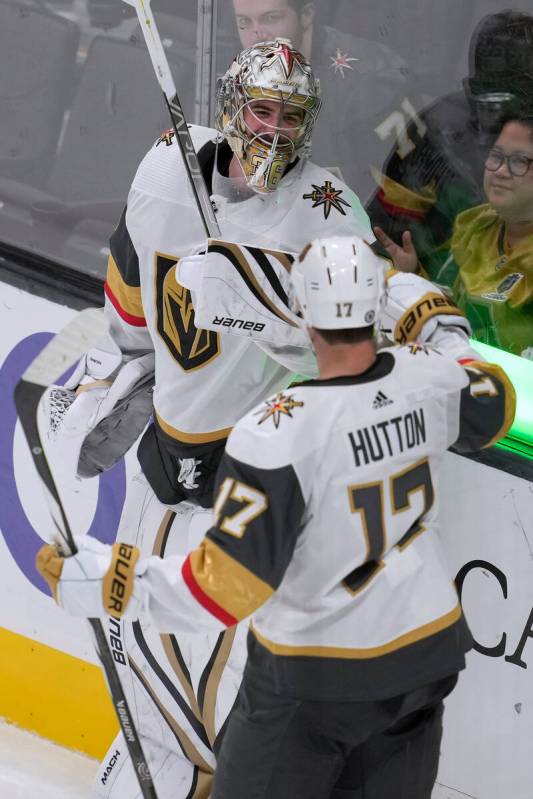 Vegas Golden Knights defenseman Ben Hutton (17) celebrates with goaltender Logan Thompson after ...