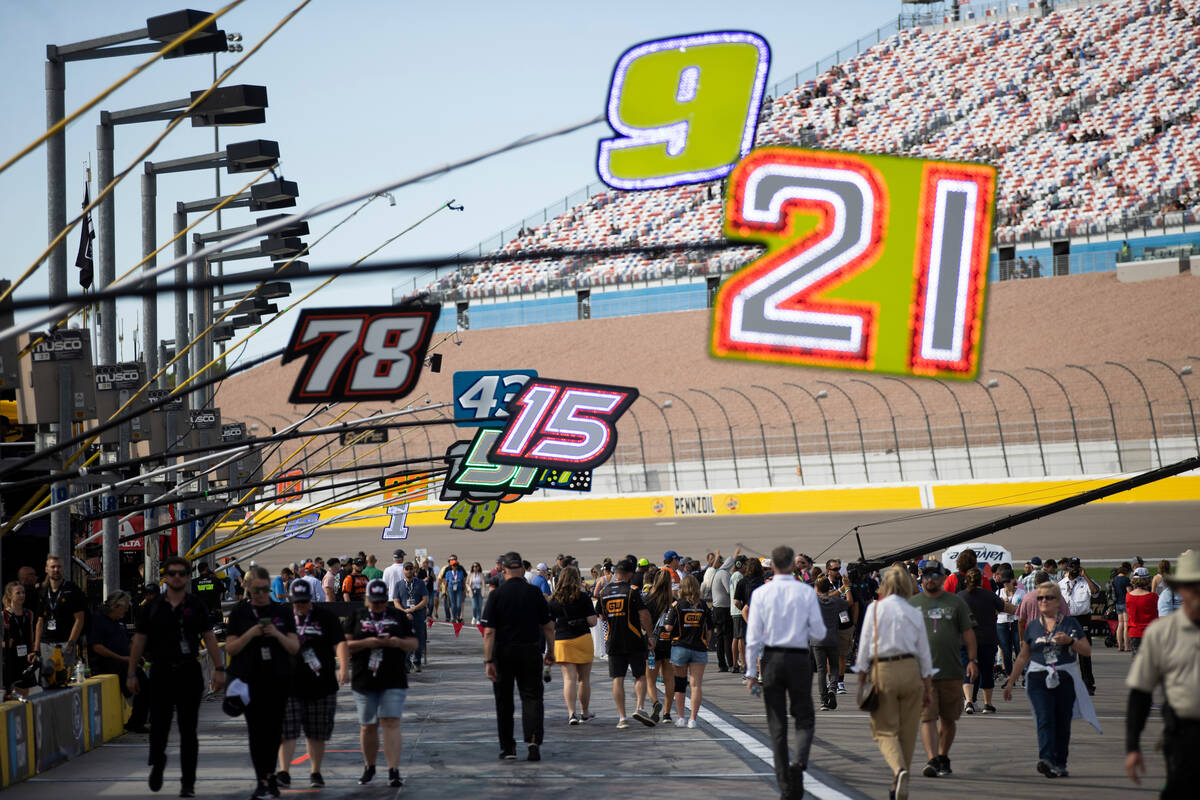 Race fans walk pit road before the South Point 400 NASCAR Cup Series playoff race at Las Vegas ...