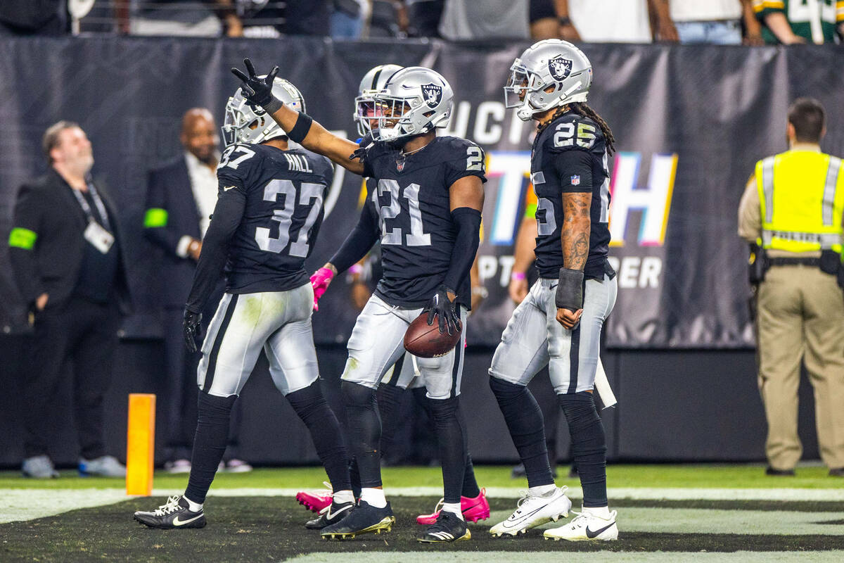 Raiders cornerback Amik Robertson (21) celebrates an interception with teammates intended for G ...