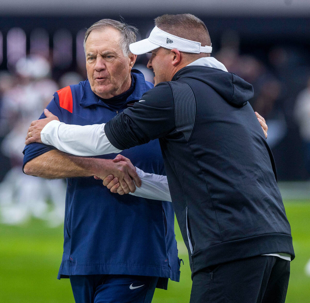 Raiders Head Coach Josh McDaniels greets New England Patriots Head Coach Bill Belichick during ...