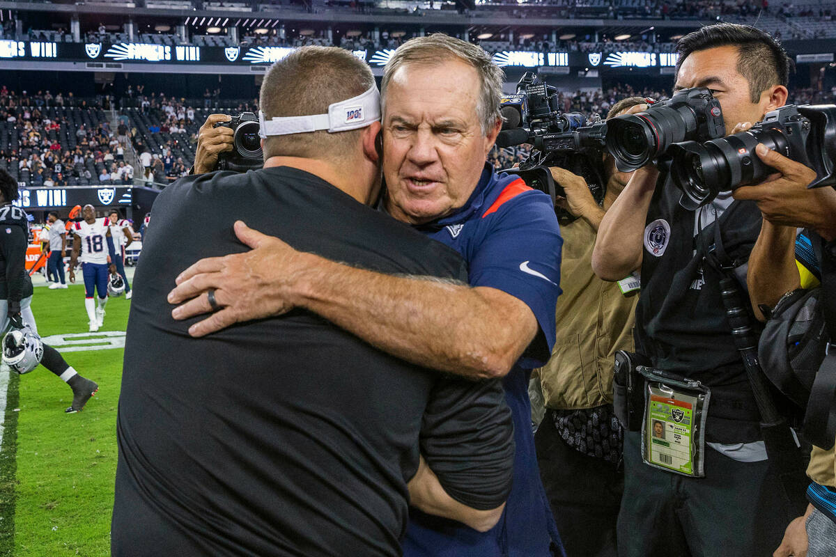 New England Patriots Head Coach Bill Belichick hugs Raiders Head Coach Josh McDaniels on the fi ...