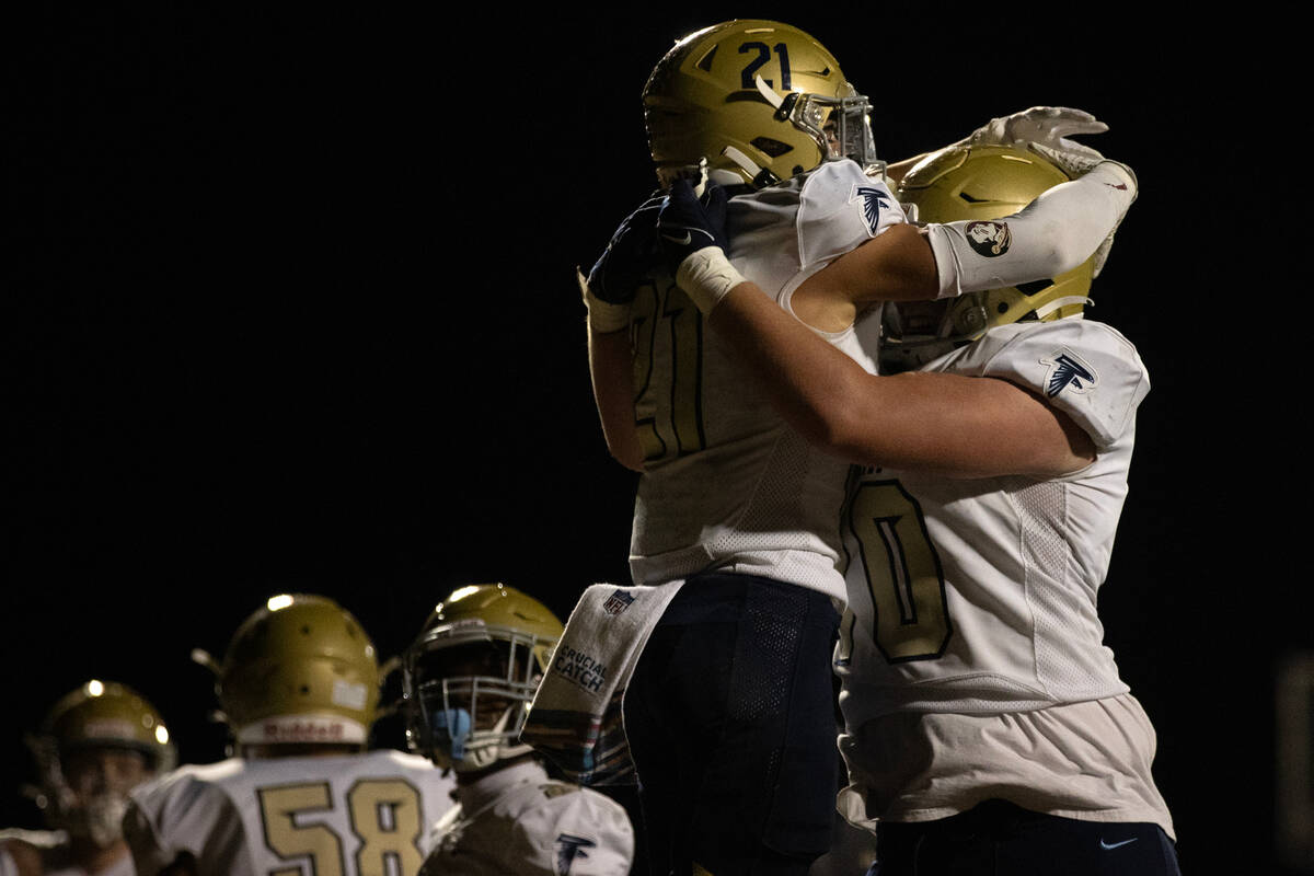 Foothill running back Avant Gates Jr. (21) and tackle Luke Abbott (70) celebrate Gates touchdow ...