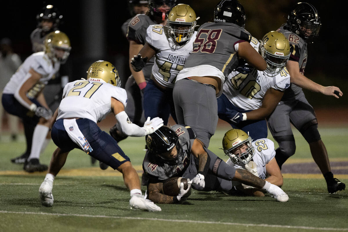 Faith Lutheran running back Cale Breslin (14) dives with the ball while Foothill strong safety ...