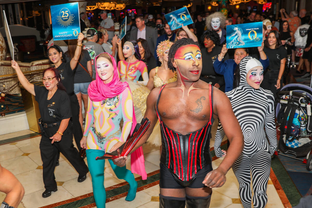 Cirque du Soleil performers walk through the Bellagio as part of the “O” annivers ...