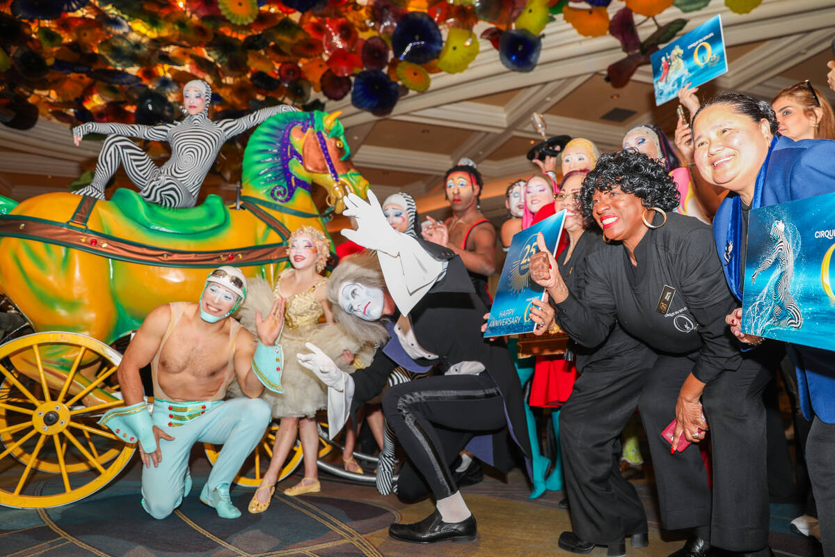 Cirque du Soleil performers and ushers walk through the Bellagio as part of the “O&#x201 ...