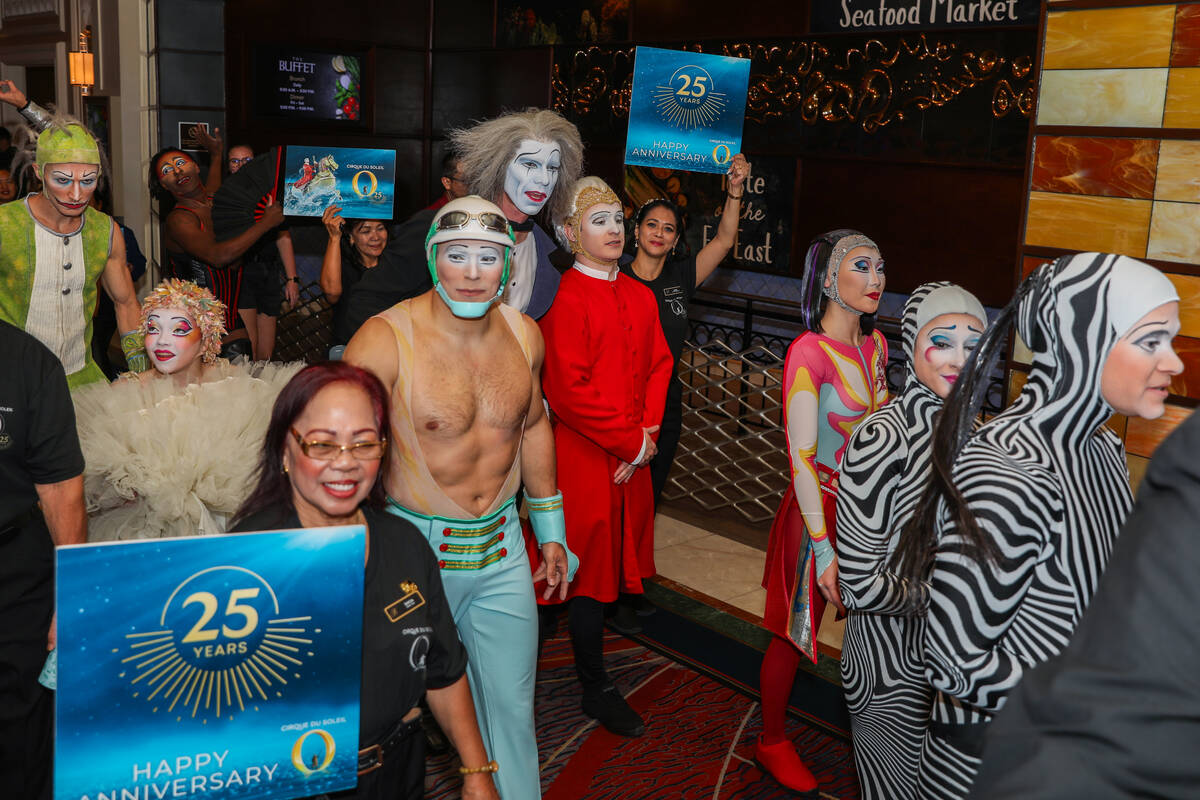 Cirque du Soleil performers walk through the Bellagio as part of the “O” annivers ...