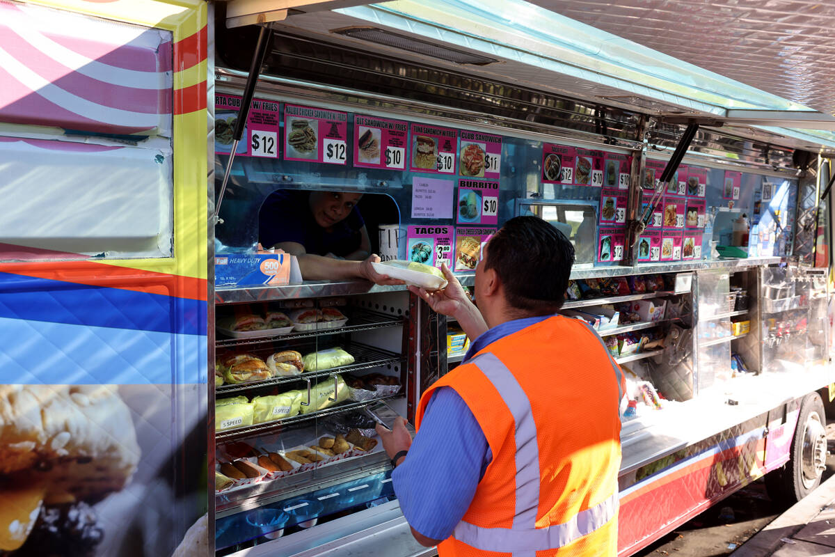 Food trucks serve customers on Elvis Presley Boulevard near the Strip in Las Vegas on Friday, O ...