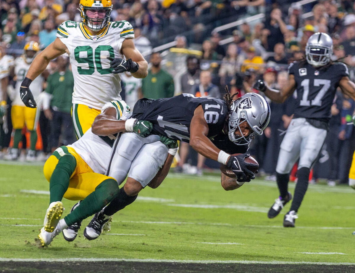 Raiders wide receiver Jakobi Meyers (16) extends over the goal line with Green Bay Packers safe ...