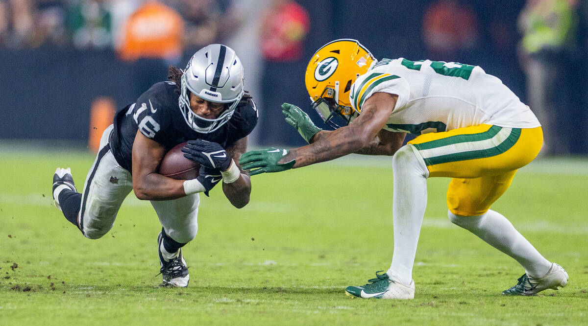 Raiders wide receiver Jakobi Meyers (16) dives for more yards against Green Bay Packers cornerb ...