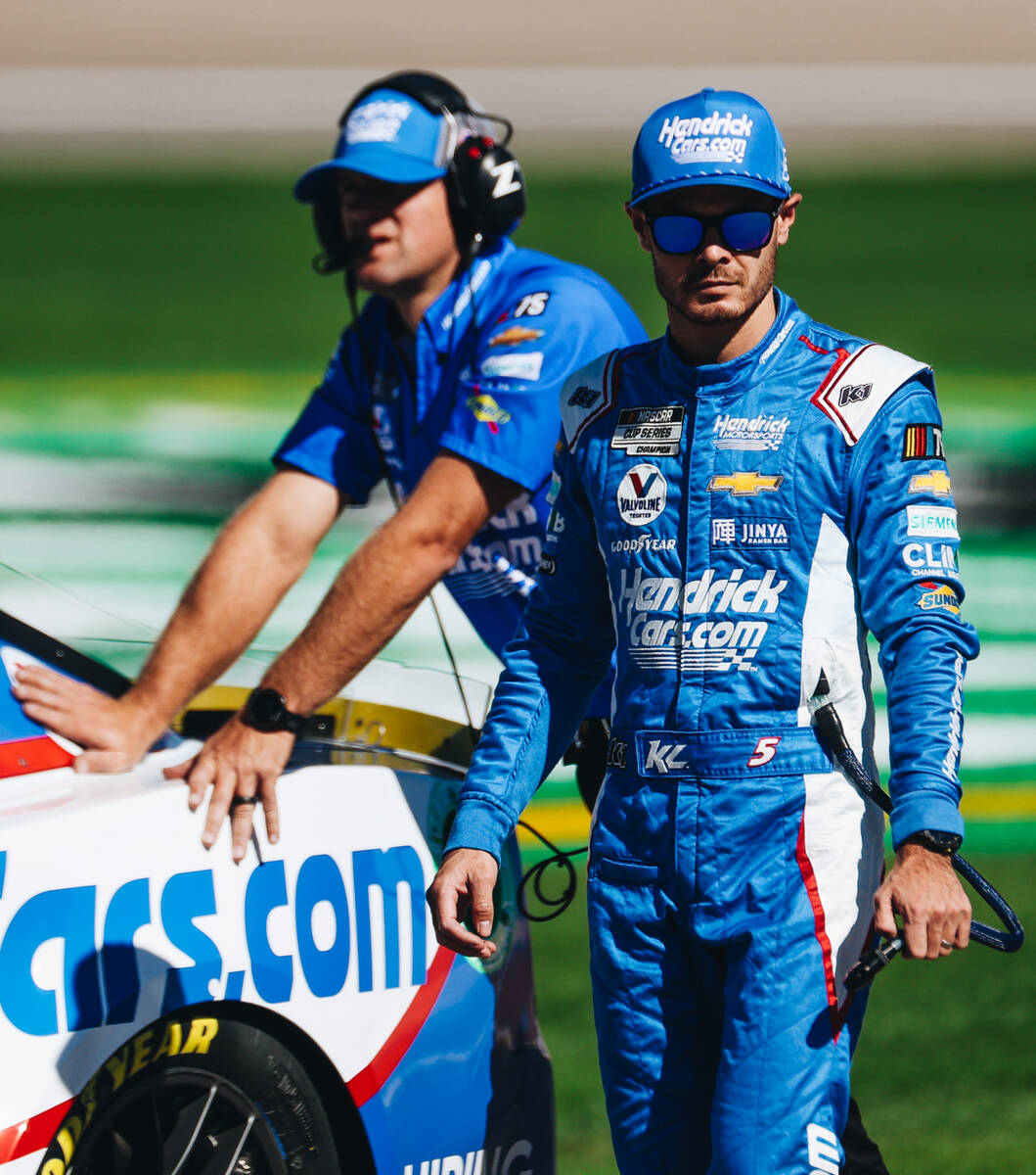 Kyle Larson walks out with his race car onto the track at the Las Vegas Motor Speedway on Satur ...