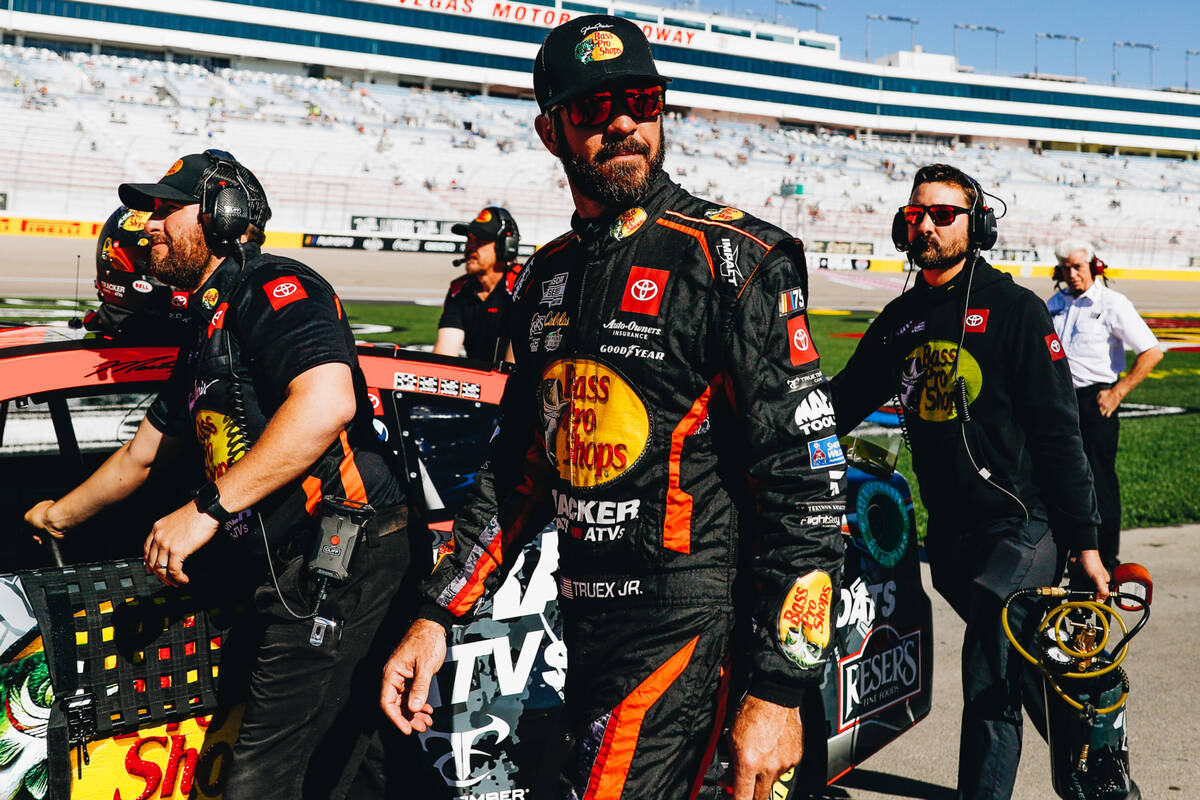 Martin Truex Jr. walks out onto the race track with his car before practicing for the NASCAR So ...
