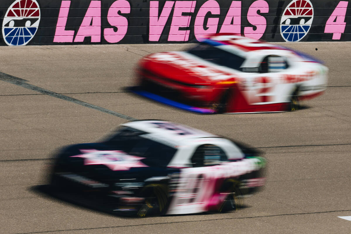 Race cars speed throughout the race track at the Las Vegas Motor Speedway on Saturday, Oct. 14, ...