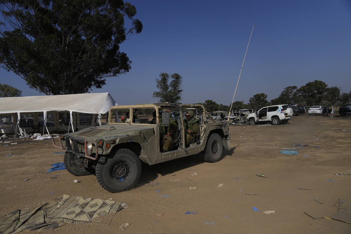 Israeli military drives through the site of a music festival near the border with the Gaza Stri ...