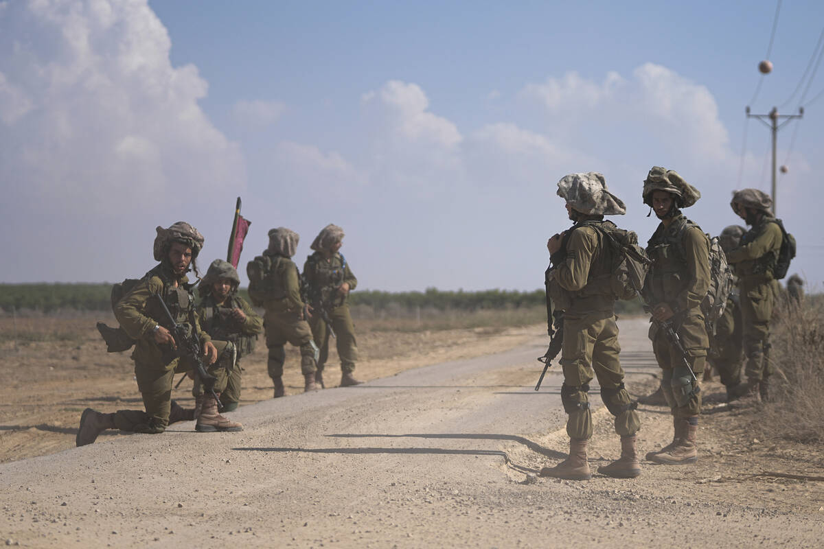 Israeli soldiers patrol next to communities near the Israeli-Gaza border, southern Israel, Frid ...