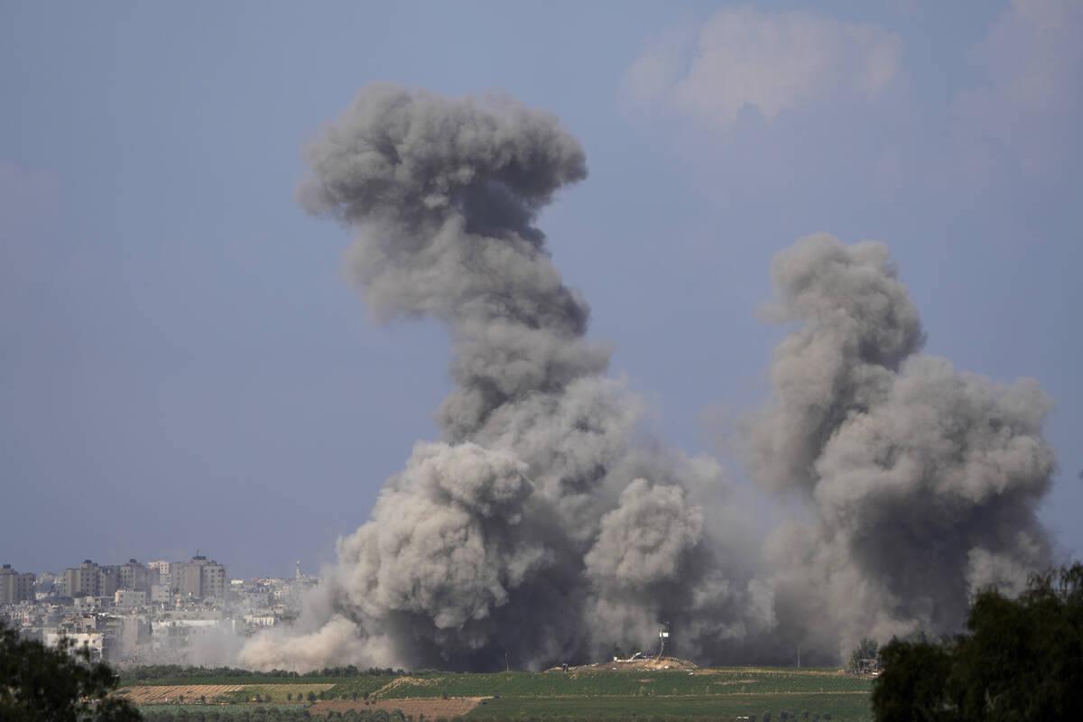 Smoke rises following an Israeli airstrike in the Gaza Strip, as seen from southern Israel, Fri ...