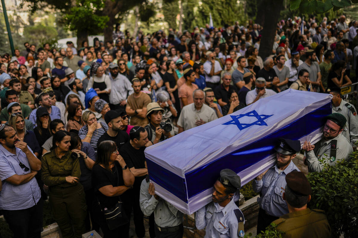 Israeli soldiers carry the flag-covered coffin of Shilo Rauchberger at the Mount Herzl cemetery ...