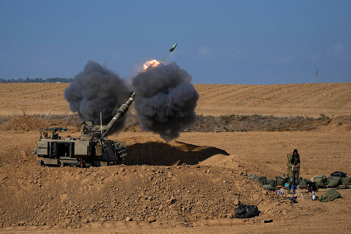 An Israeli mobile artillery unit fired a shell from southern Israel towards the Gaza Strip, in ...