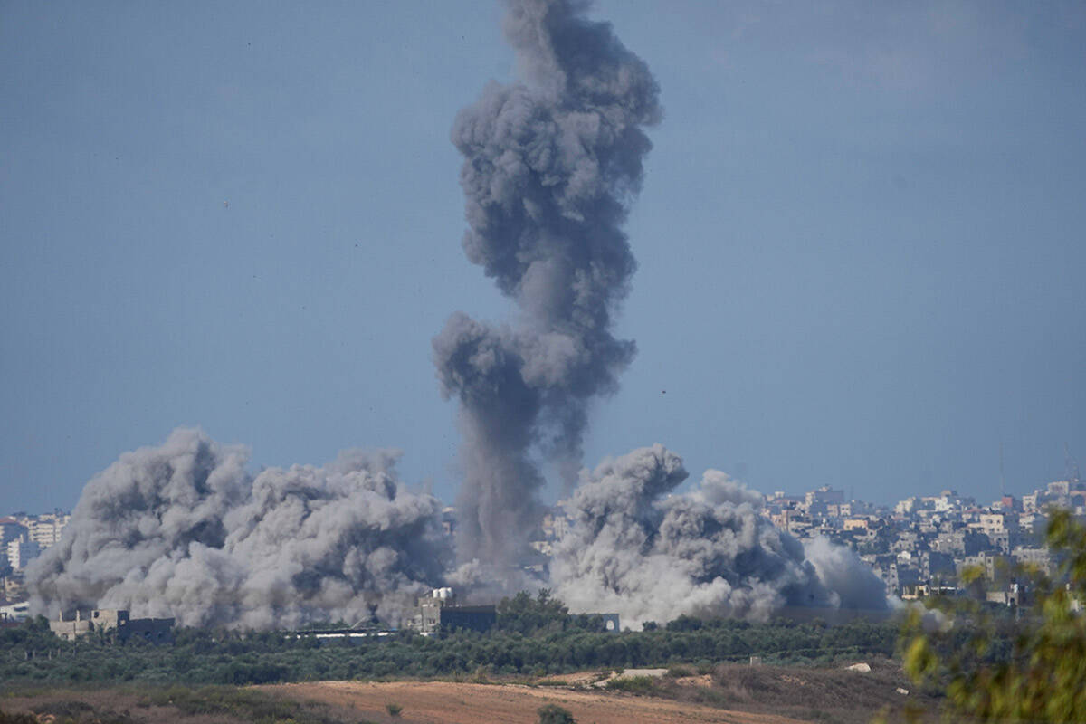 Smoke rises following an Israeli airstrike in the Gaza Strip, as seen from southern Israel, Sun ...