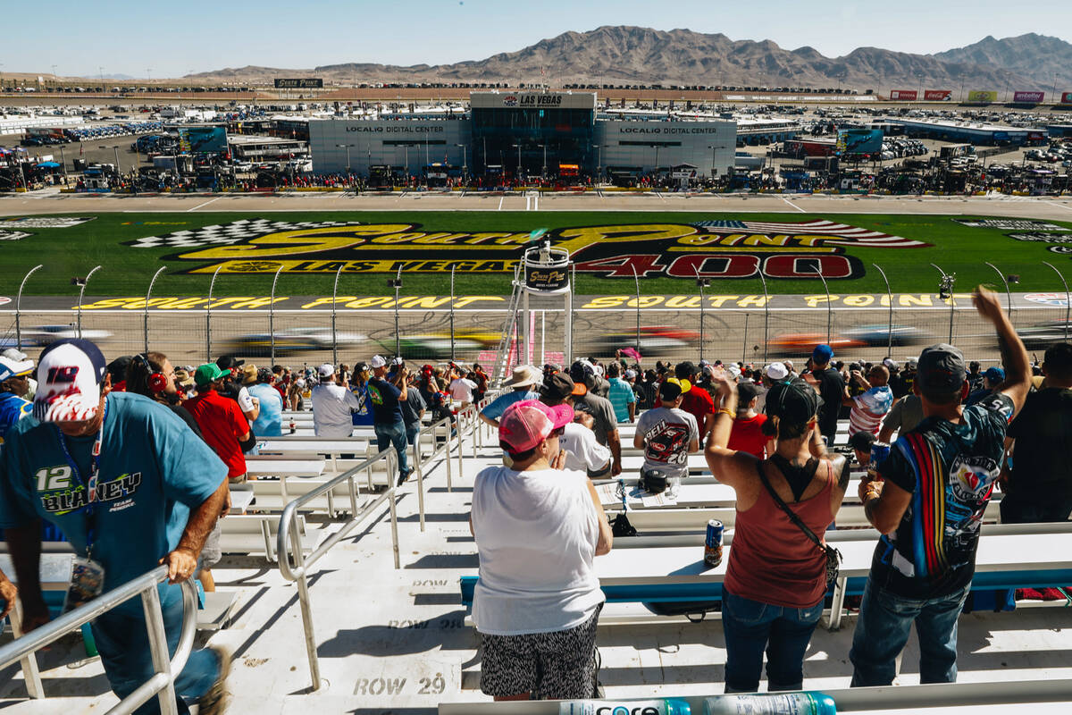 Cars race by as fans cheer during the South Point 400 at the Las Vegas Motor Speedway on Sunday ...